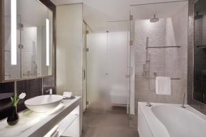 a bathroom with a tub and a sink and a shower at W Abu Dhabi - Yas Island in Abu Dhabi