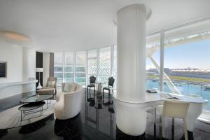 a living room with white furniture and a large window at W Abu Dhabi - Yas Island in Abu Dhabi