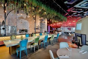 a dining room with a long table and chairs at W Abu Dhabi - Yas Island in Abu Dhabi