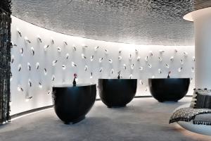 a room with three black bowls against a wall at W Abu Dhabi - Yas Island in Abu Dhabi