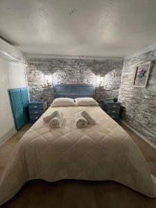a bedroom with a large bed with towels on it at A Casa do Mestre Lau - no coração do Alentejo in Terena