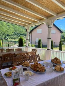 a table with several plates of food on it at Lola Guest House in Vusanje