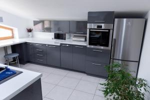 a kitchen with a stainless steel refrigerator and appliances at Apartament - Bystra in Bystra
