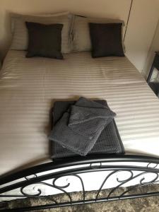 a bed with black and white sheets and pillows at Alpha house in London
