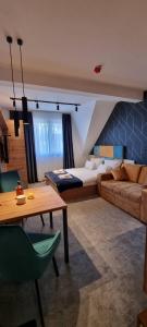a living room with a bed and a couch at Dana Apartmani in Kopaonik