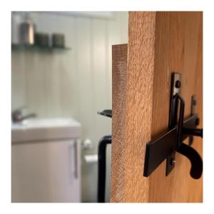 a close up of a wooden door with a handle at Cobo Cottage in Chichester