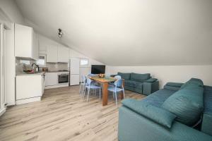 a living room with a blue couch and a table at Apartments Picikato in Bilice