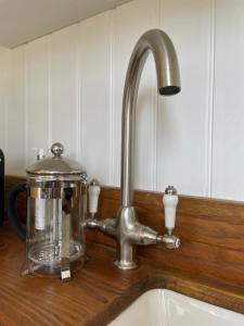 a kitchen sink with a kitchen faucet and a mixer at Cobo Cottage in Chichester
