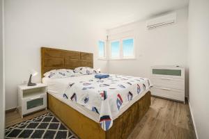 a bedroom with a large bed and a window at Apartments Picikato in Bilice