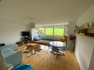 a living room with a couch and a table and chairs at Natur Pur im Hochschwarzwald in Herrenschwand