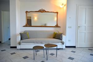 a couch in a room with two chairs and a mirror at Le Drupe in Chiavari +73 photos