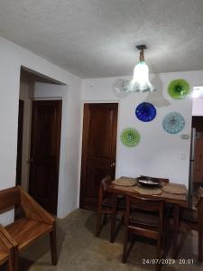 a dining room with a table and plates on the wall at Ixtapa al mejor precio, "Casa las Conchas" in Zihuatanejo