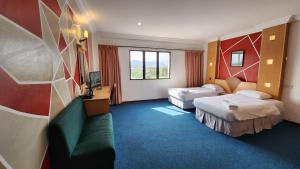 Postel nebo postele na pokoji v ubytování Fair Park Hotel