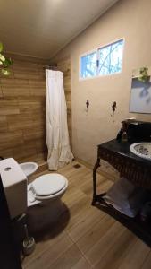 a bathroom with a toilet and a sink at El campito in Capilla del Señor