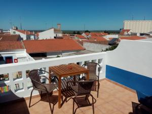 a patio with a table and chairs on a balcony at Alentejo Cante & Vinho in Ferreira do Alentejo