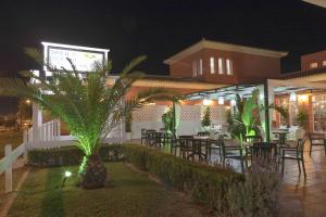 a restaurant with tables and chairs at night at Hostal Rte. Casa Miguel in Matalascañas