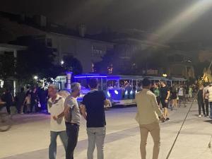 a group of people standing on a street at night at Apartment in Buyukcekmece