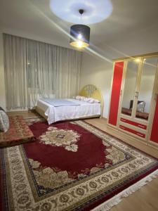 a bedroom with a bed and a rug at Apartment in Buyukcekmece