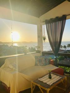 a bedroom with a bed and a view of the ocean at Vista Surf Pipa Hostel in Pipa