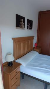 リベイラにあるPeñisqueiraのベッドルーム1室(ベッド1台、ランプ付きテーブル付)