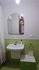 a bathroom with a sink and a mirror at Peñisqueira in Ribeira