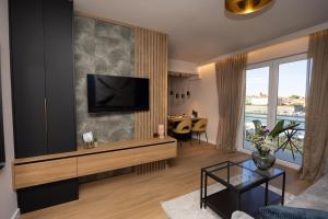 a living room with a flat screen tv on a wall at Aurum Ponte Deluxe in Zadar