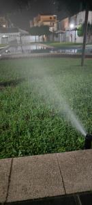 a fire hydrant spraying water on a field of grass at Estudio de Lujo in Torrevieja +14 photos