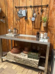 a table with plates and utensils on a wall at Secluded Lakeside Off Grid Cabin with Outdoor Bath in Rhosneigr