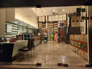 a store front with a person walking through a store at Fair Park Hotel in Ipoh