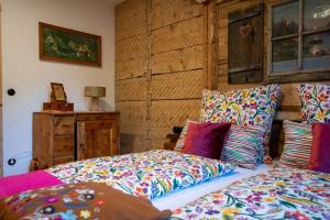 a bedroom with two beds with colorful pillows at Edt 19 in Bad Goisern
