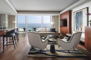 a living room with a view of the ocean at The Ritz-Carlton Bal Harbour, Miami in Miami Beach