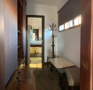 a hallway with a room with a table and a mirror at Hospedaria Canto do Vinhedo in Espirito Santo Do Pinhal