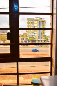 a view of a city from a window at Karibu Place Kamakis- Opp Greenspot Gardens in Ruiru