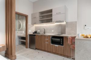 a kitchen with a sink and a stove at Phaos Residence, Your Stylish Crete Retreat in Panormos Rethymno +22 photos