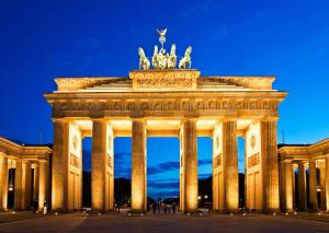 a brandenburg gate lit up at night at WonderFlat for Wonderful people in Berlin