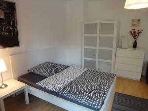 a small bedroom with a bed and a white cabinet at WonderFlat for Wonderful people in Berlin