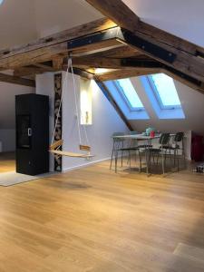 a room with a table and chairs and skylights at Loft im Haus mit Geschichte in Mähring