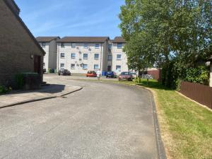 an empty street in front of a building at Argyll Apartment Loch Lomond in Balloch