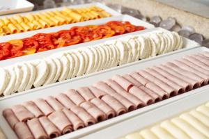 a row of different types of hot dogs on display at Cris Hotel in Florianópolis