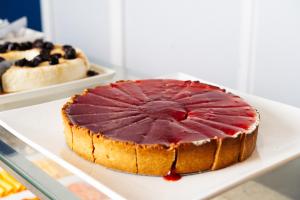 a cake sitting on a white plate on a table at Cris Hotel in Florianópolis