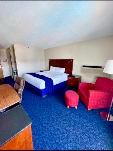 a hotel room with a bed and a red couch at Islander Inn in Put-in-Bay