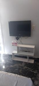 a flat screen tv sitting on a white tv stand at مدينتي in Madinaty