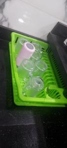 a green tray with measuring cups and a pair of scissors at مدينتي in Madinaty