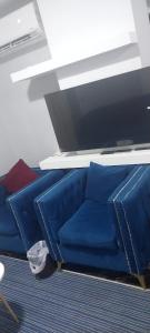 a blue couch in a room with a table at مدينتي in Madinaty
