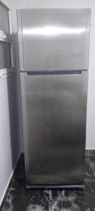 a stainless steel refrigerator sitting in a kitchen at مدينتي in Madinaty