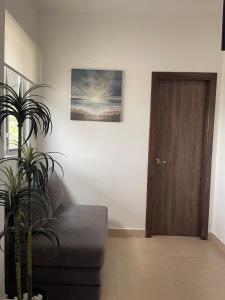 - un salon avec un canapé et une porte en bois dans l'établissement Hermoso hogar con bbq y piscina en Punta Blanca, à Punta Blanca