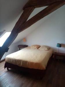 a bedroom with a large bed in a attic at Logement studio dans un coin paradisiaque 