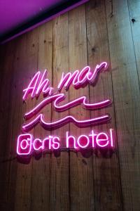 a neon sign that says all new dogs house at Cris Hotel in Florianópolis