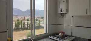 een keuken met een fornuis en een groot raam bij Casa Torres in Tetouan