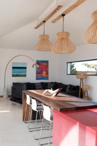 a living room with a large wooden table and chairs at Casa Mila with heated pool in El Roque in Cotillo